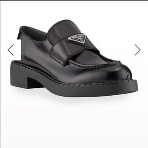 Prada leather loafers with triangle logo keeper.